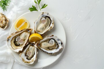 Wall Mural - Fresh oysters with lemon on white plate top view on tablecloth With space for text