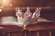 Low key image of diamond crown on old book vintage filter with glitter overlay Selective focus Medieval concept