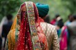 Hindu bride follows husband carrying garb