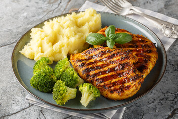 Canvas Print - Roast breast grilled chicken with broccoli and mashed potatoes closeup on the plate on the table. Horizontal