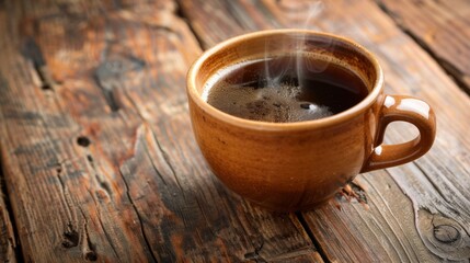 Poster - A steaming cup of freshly brewed coffee on a rustic wooden table, with aromatic steam rising invitingly from the dark brew.