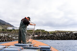 Fototapeta Konie - Fisherman on the deck of a lobster fishing boat