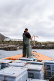 Fototapeta Konie - Fisherman on a lobster fishing boat mooring the boat