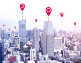 Fototapeta Kwiaty - Network connection concept. Aerial view on Tokyo capital city of Japan with red location pin. Global positioning system pin map. Map pins in Tokyo. Modern travel, sightseeing and tourism concept
