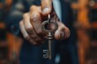 A businessman holds up a key, signifying the pivotal decisions and actions that unlock doors to success and opportunity