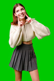 Fototapeta  - Smiling Young Woman Posing in Casual Clothing Against a Green Background
