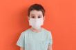 Child medical mask on orange background
