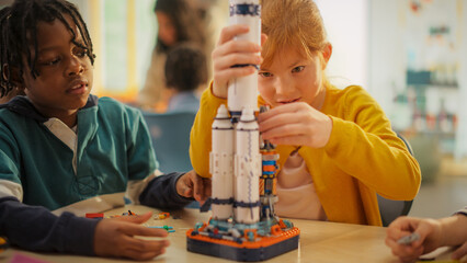 smart boys and talented girls making a model of a modern multiplanetary space rocket. young gifted f