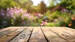 The wooden table top stands empty, with the background of a garden in a delightful blur. For Design, Background, Cover, Poster, Banner, PPT, KV design, Wallpaper