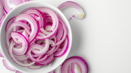 Wall Mural - Onion slices in a white bowl on a white table, top view, space on the right