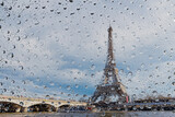Fototapeta Do przedpokoju - View on Paris city through water drops on glass after rain. Weather and forecast concept.