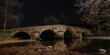 stone bridge at the night. under exposure photo. medieval concept.