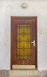 Wooden Door With Yellow Window and Bars House Entrance