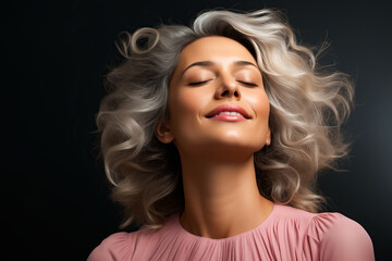 Wall Mural - Woman with her eyes closed and her hair blowing in the wind.