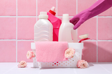 Wall Mural - Detergents in a basket on a pink background