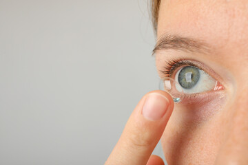 Wall Mural - Installation of a contact lens in the eye close-up