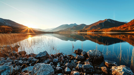 Wall Mural - Beautiful mountain lake with water reflections at sunset and golden light during autumn