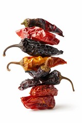 Sticker - A stack of colorful dried chili peppers isolated on a white background