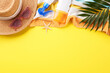 A top-view photo displaying beach accessories with vibrant yellow background, perfect for summer promotions and editorial content