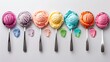 A row of colorful scoops of ice cream on spoons with melting drips below