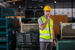 Male professional walkie talkie control worker in warehouse. Supervisor import-export shipping transportation, logistic business factory concept.