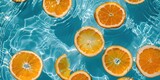 Fototapeta Kosmos - Creative summer background with orange fruit slices in swimming pool water. Summer wallpaper