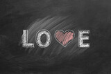 Fototapeta  - LOVE word with heart shape hand drawn on blackboard. Valentines day, love, compassion concept.
