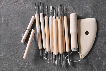 Poster - Set of different clay crafting tools on grey table, top view