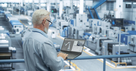 Fototapete - Portrait of a Handsome Middle Aged Engineer with Glasses Using Laptop Computer and Looking Around a Factory Facility with Equipment Producing Modern Electronic Components for Different Industries