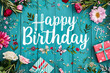 Happy Birthday quote surrounded by flowers on a light blue wooden ground, brithday background, card design