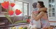 Image of flowers icon over happy biracial adult daughter embracing mother in kitchen