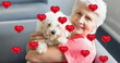 Image of heart icons over smiling senior woman holding dog