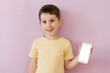 Boy with smartphone on pink background