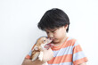 Asian boy hugging dog and looking together