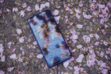 Fototapeta Boho - Close up of a mobile phone on the ground
