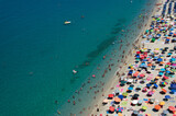 Fototapeta Pokój dzieciecy - Aerial view of sandy beach with swimming people in sea with transparent blue water in summer.