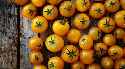 Wall Mural - A bunch of orange tomatoes neatly arranged on a wooden surface, showcasing their vibrant color and freshness
