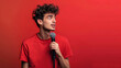 © DrPhatPhaw - Young man introducing himself with a microphone on isolated wallpaper