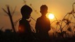Two boys stand in front of a barbed wire fence at sunset.