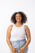 Biracial young female plus size model stands with hands on hips, white background