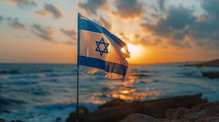 The Israeli flag stands proud against a sunset backdrop by the sea, symbolizing hope and resilience