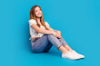 Full length portrait of lovely girl look empty space imagine wear top isolated on blue color background