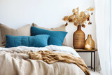Fototapeta  - Bed with blue and beige bedding. Boho, farmhouse interior design of modern bedroom.