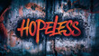 Rough grunge textured urban concrete wall with spray painted word 'hopeless' and random scribbles on it's surface, thought provoking concept with copy space for extra text and phrases.