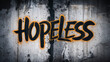 Rough grunge textured urban concrete wall with spray painted word 'hopeless' and random scribbles on it's surface, thought provoking concept with copy space for extra text and phrases.