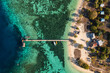 Komodo, Indonesia: Top down view of the Kanawa island with beach bungalows, the jetty and reef in Komodo islands near Labuan Bajo in Flores, Indonesia.