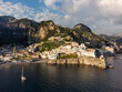 Amalfi, Italy: Dramatic aerial of the famous Amalfi village with its beach and old church and stunning coast near Napoli in Italy
