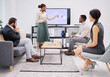 © peopleimages.com - Woman, presentation and point at screen in office with business people with feedback for market survey. Person, speaker and presenter for info, statistics or review with charts on monitor with staff