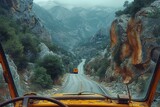 Fototapeta  - A trucker's view from the cab as they navigate a winding mountain road, with steep cliffs and hairpin turns