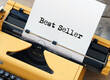 Yellow typewriter with word best seller on paper sheet